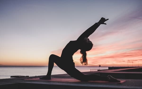 Senior practicing gentle yoga outdoors